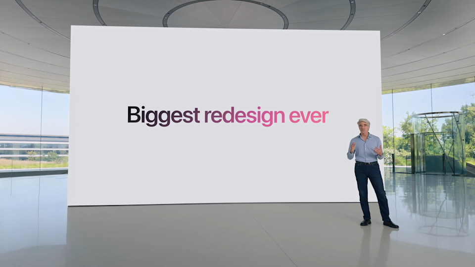 Apple's Craig Federighi standing in front of a board tha reads,