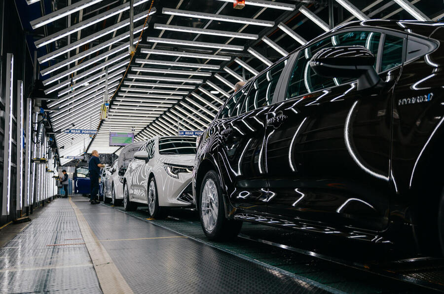 Cars on an assembly line in a factory.