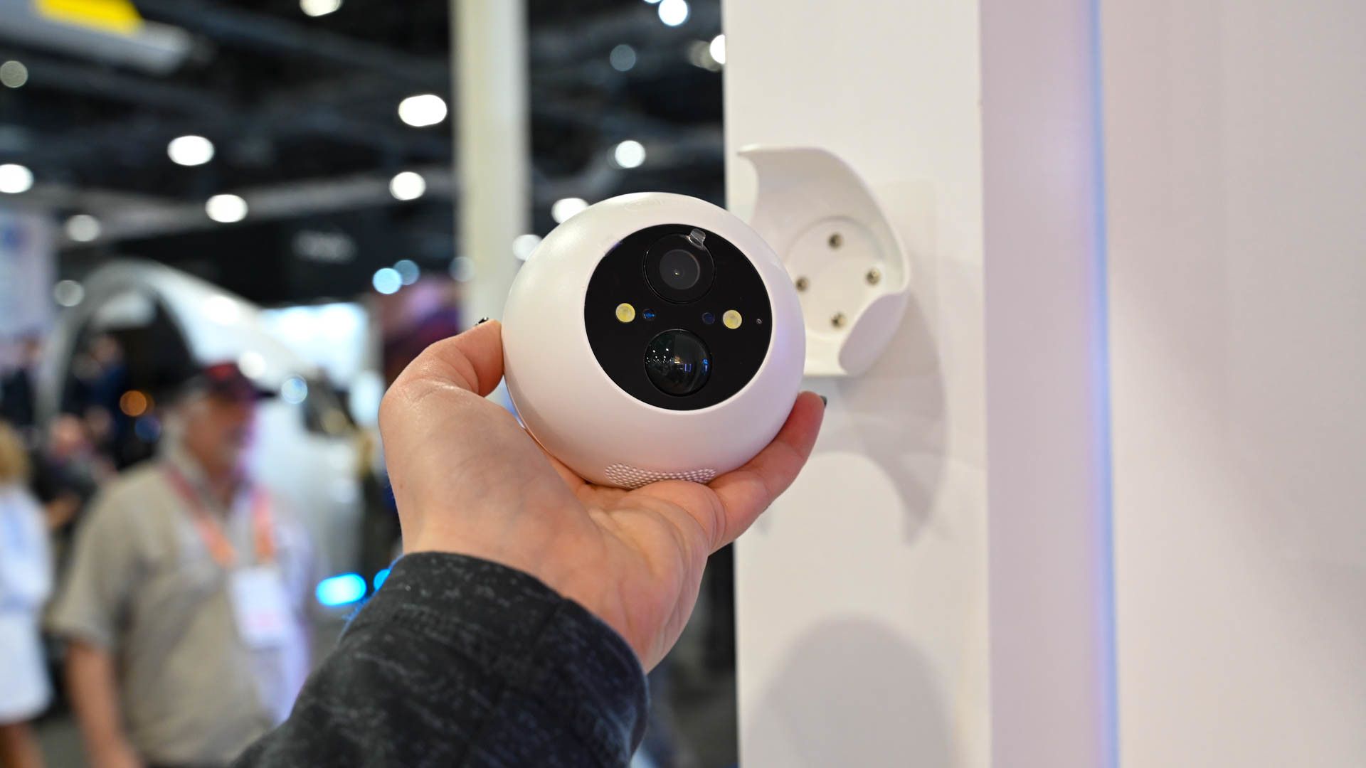 Person holding SwitchBot Outdoor Spotlight Cam