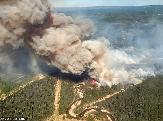 The alert comes as the Midwest is also facing air quality emergencies due to wildfire smoke crossing the border from Canada. Smoke rises from Edith Lake wildfire, which forced the evacuation of the nearby town of Swan Hills, Alberta, Canada in an aerial photograph