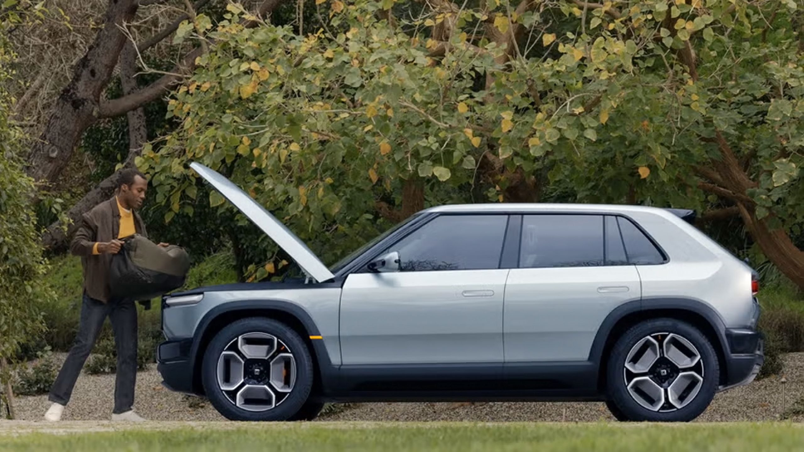 Loading cargo into the Rivian R3's frunk.
