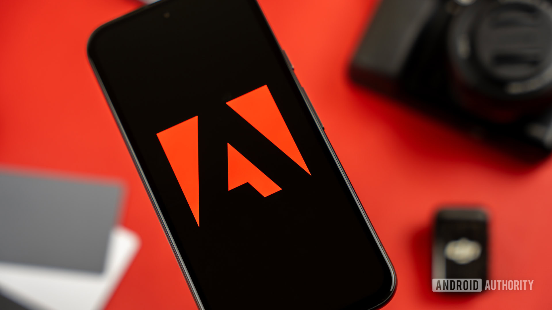 Adobe logo on smartphone, next to photography and videography products stock photo (6) Adobe logo on smartphone, next to photography and videography products stock photo (6)