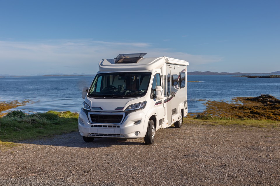 Motorhome parked overlooking ocean.