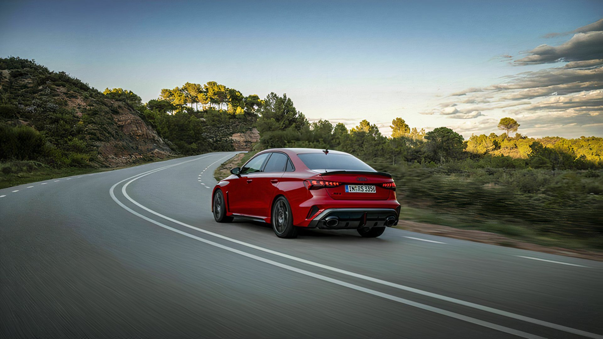 Rear three-quarter view of a red Audi RS 3 Sedan